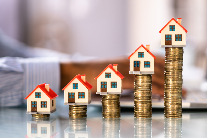 immobilienmakler-frankfurt-eckenheim-dornbusch-immobilien-münzenstapel-auf-denen-häuser-stehen